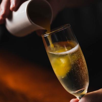 Hands pouring a beer in a glass.