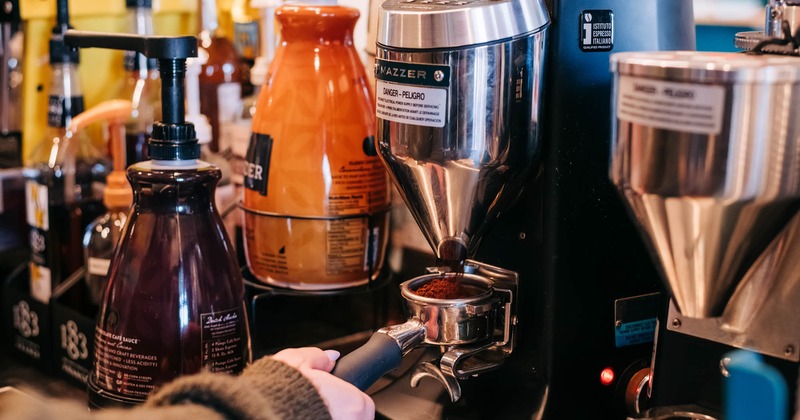 A hand operating the coffee machine