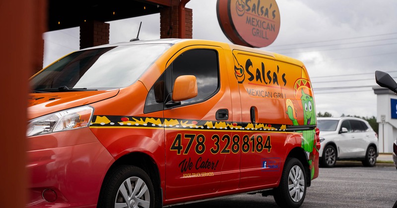 Colorful food truck with the logo and phone number