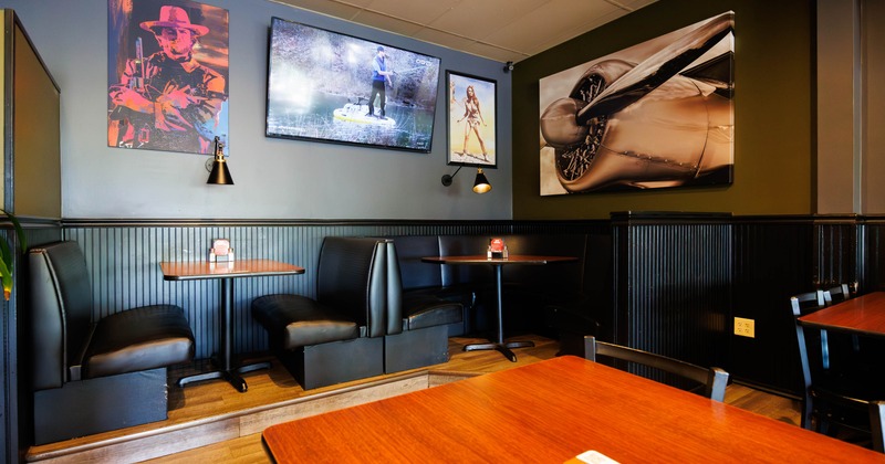 Dining area with booth seating, artwork on the walls