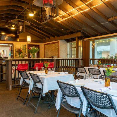 Dining area with set tables, chairs, and pendants lights.