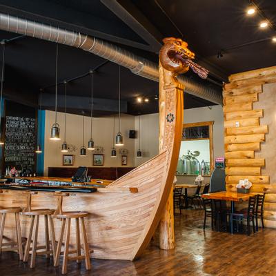 Interior, a wooden viking boat bar with wooden stools, and seating area