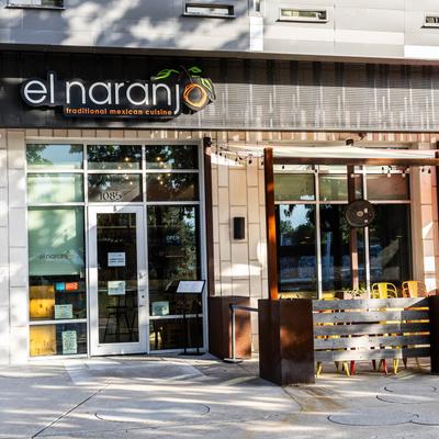 The exterior of El Naranjo restaurant with outdoor seating.