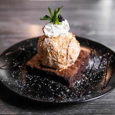 Grand Finale dessert, a brownie topped with vanilla ice cream and cream
