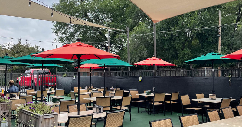 Outdoor seating area with red and green parasols