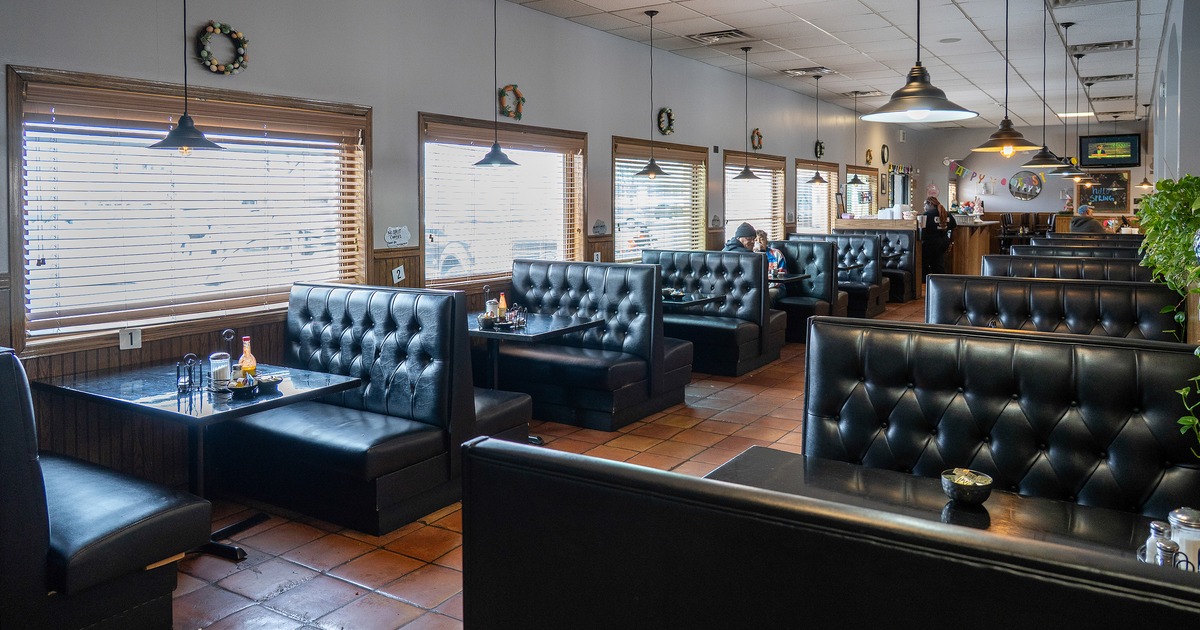 Cozy interior dining area with black upholstered dining booths