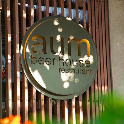 A circular metal cut-out sign featuring the restaurant's logo.