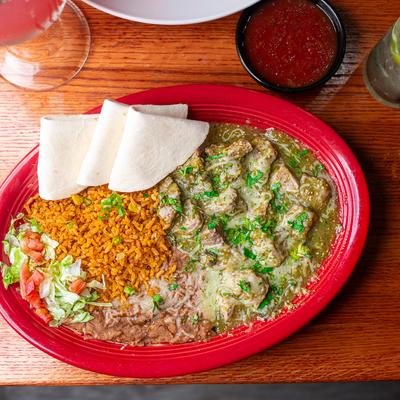 Carne Asada with green salsa, rice, refried beans, and fresh tortillas.