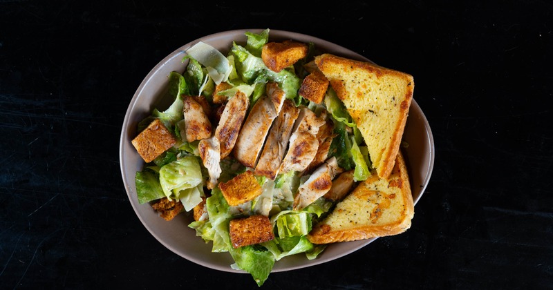 Grilled chicken Caesar salad, overhead view