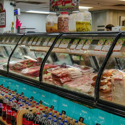 Refrigerated meat display counter in a grocery store.
