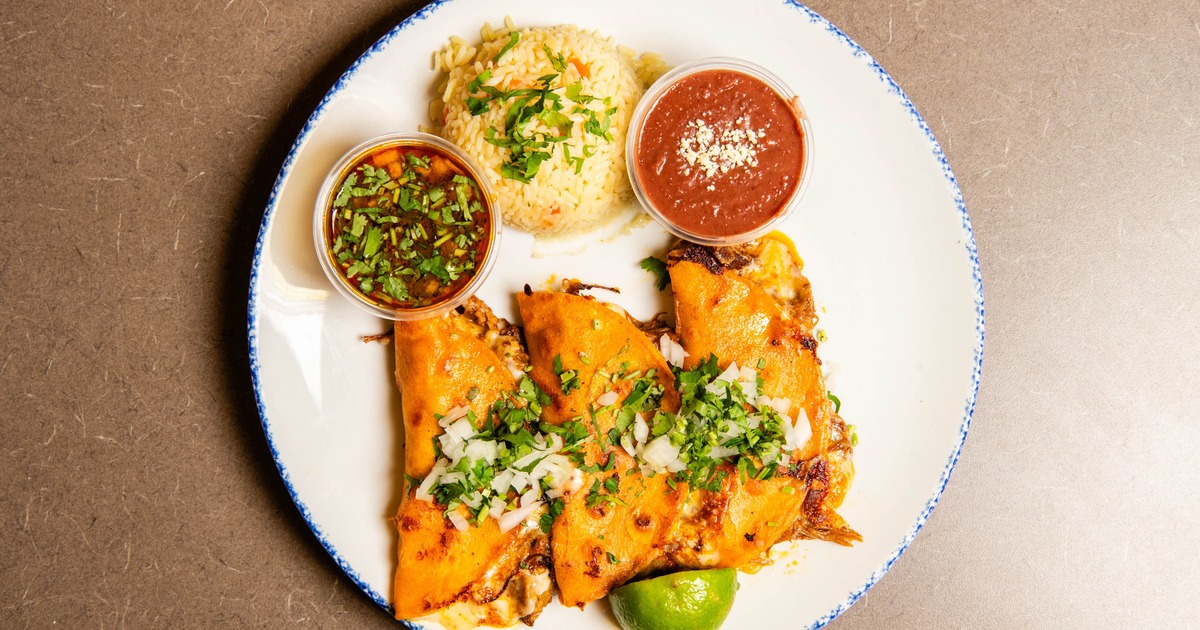 Portion of Birria Tacos with rice, beand and a dip, top view
