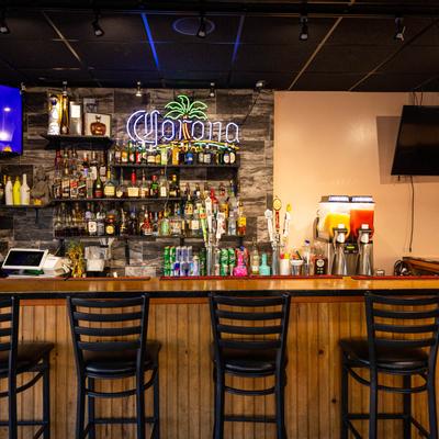 Interior, the bar with stools and wall TV sets