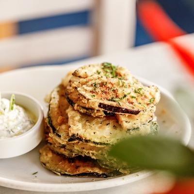 Eggplant and zucchini chips served with tzatziki cup on the side.