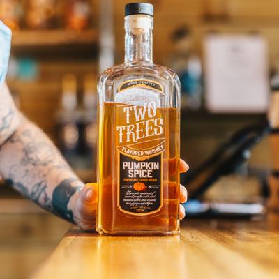 A hand holding a bottle.