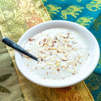 Rice pudding topped with sliced nuts.
