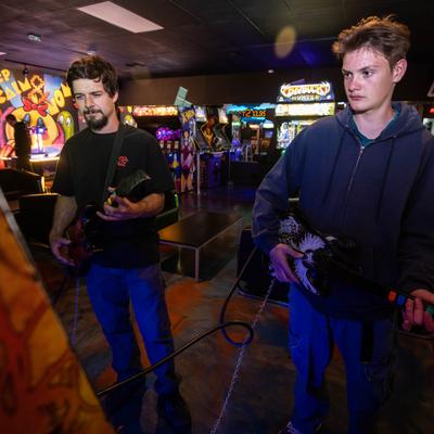 Two guests playing Guitar Hero.