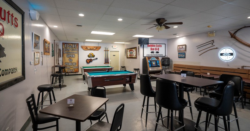Interior, seating and game area, high and regular seating, pool tables and jukebox in the back