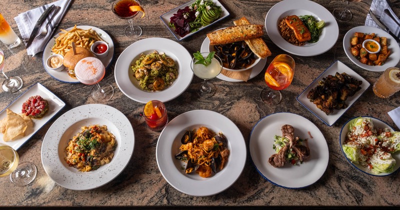 Assorted dishes and cocktails arranged on a table