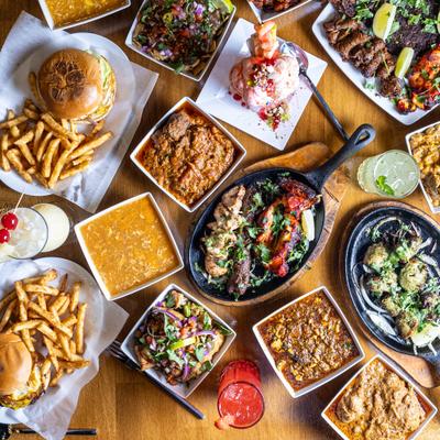 A variety of dishes and drinks placed on a wooden table.