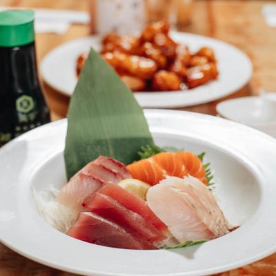Sashimi plate with assorted sliced fish pieces.
