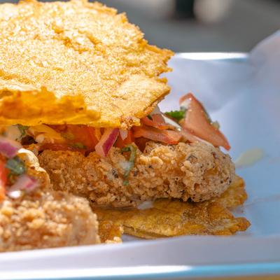 Fried catfish sandwich in crispy cornmeal crust.