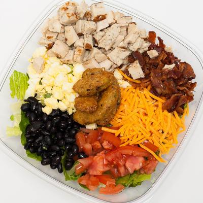 Cobb Salad, with chicken, bacon, cheddar, black beans, fried avocado, tomato, and boiled egg.