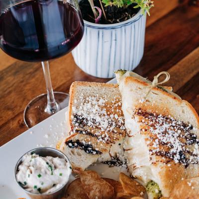 Basil Pesto Grilled Cheese sandwich with a glass of red wine.