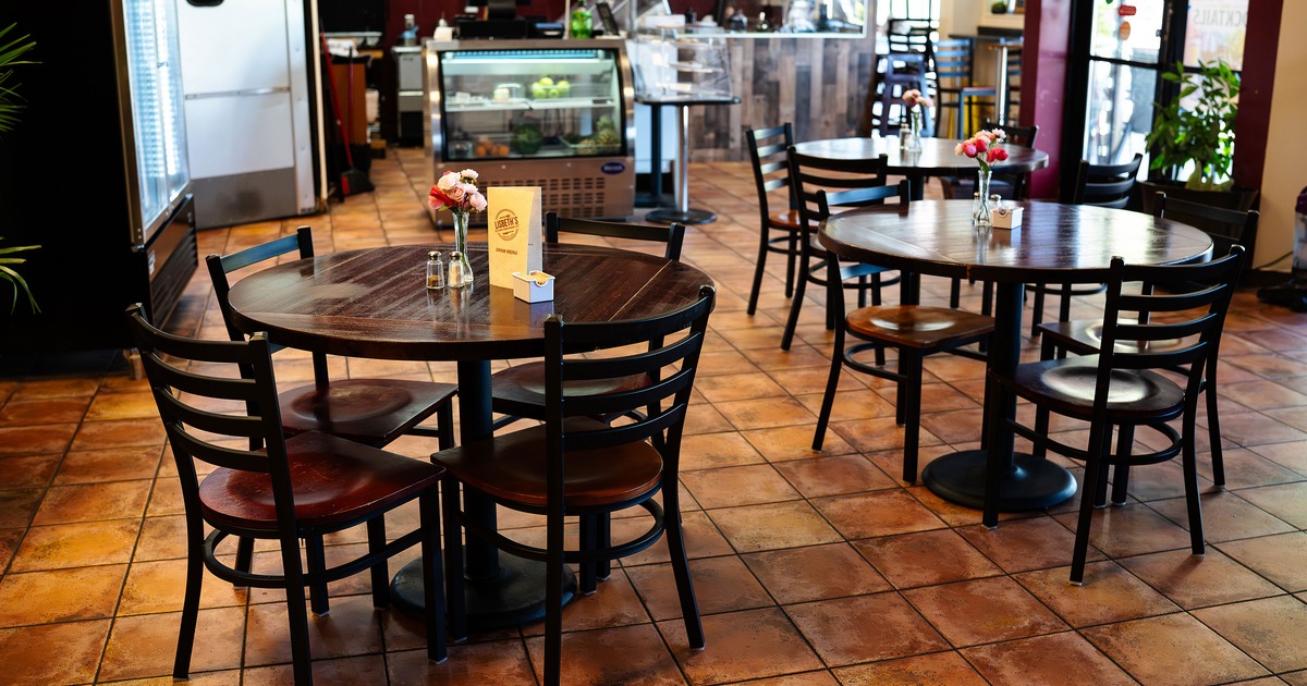 Dining area with round wooden tables for four guests