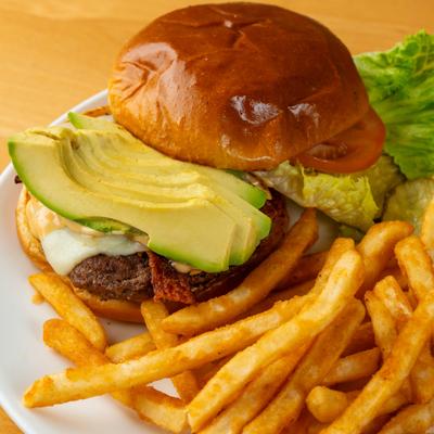 Bacon cheeseburger with avocado and fries.