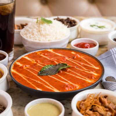Butter chicken with side dishes.