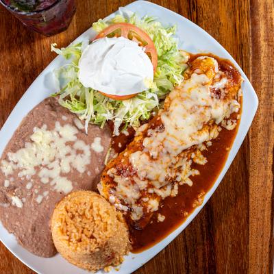 Tequila burrito with rice, refreid beans, lettuce, and sour cream.