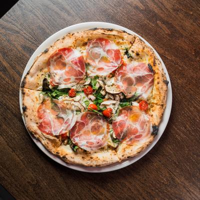 Four Season pizza with coppa, mushrooms, spinach, tomatoes and mozzarella.