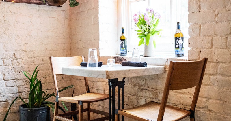 Table for two next to the window with plant pots