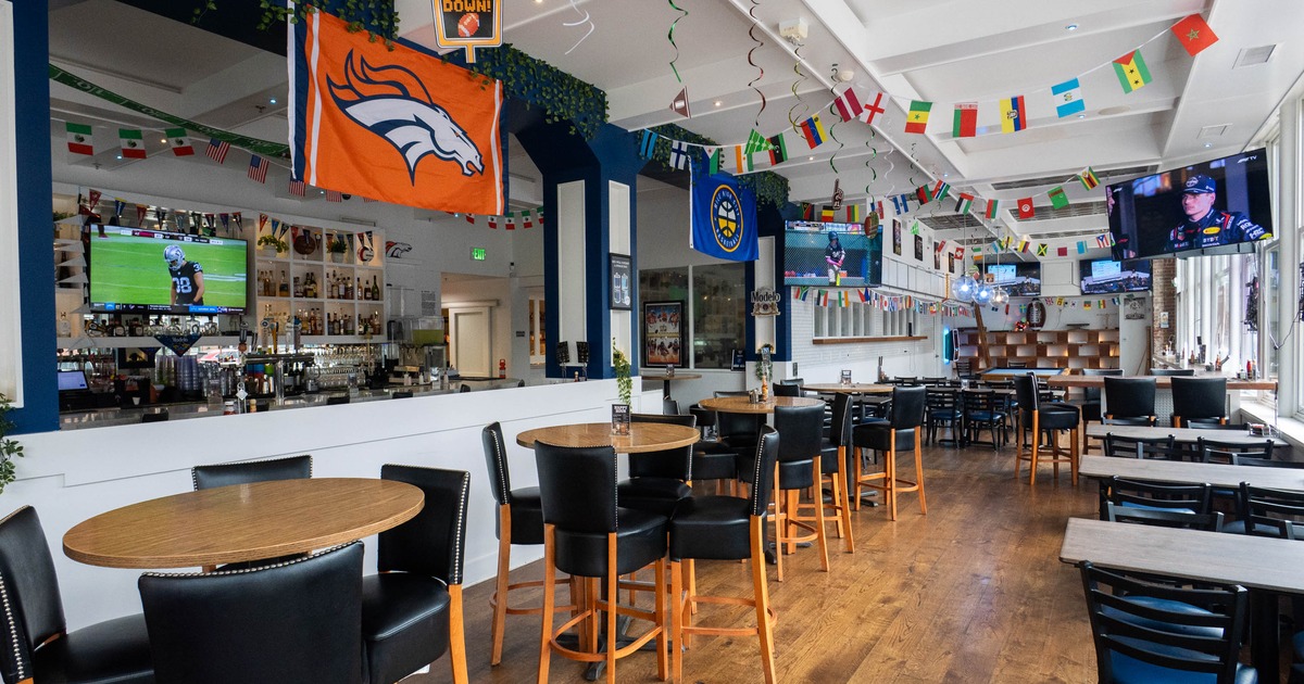 Interior, high and regular seating area, round tables for four, bar in the back