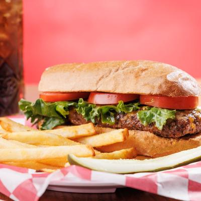 Cheeseburger with tomato and lettuce, served with  fries.