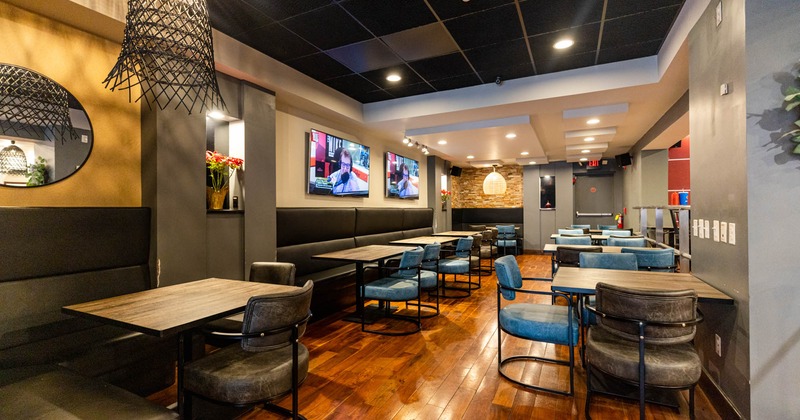 Interior, dining area, TV screens on the wall, plants