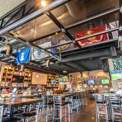 Restaurant dining area, flags hanging from ceiling.
