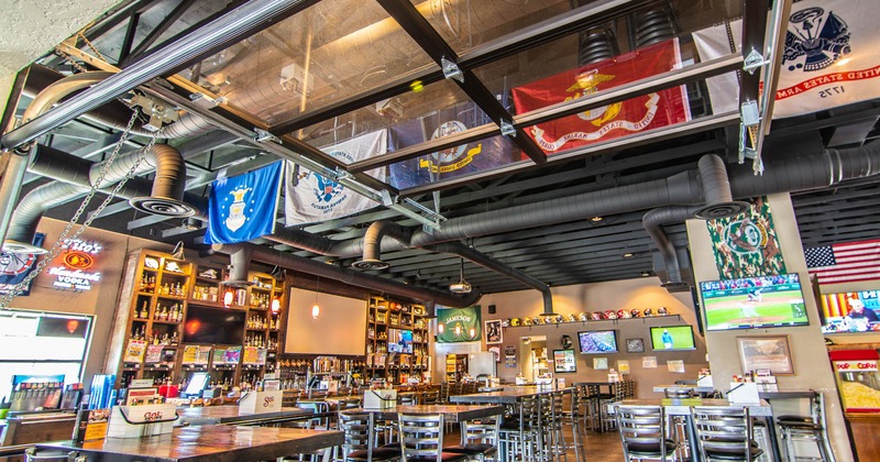 Interior, seating area, flags hanging from the ceiling, TVs on the walls