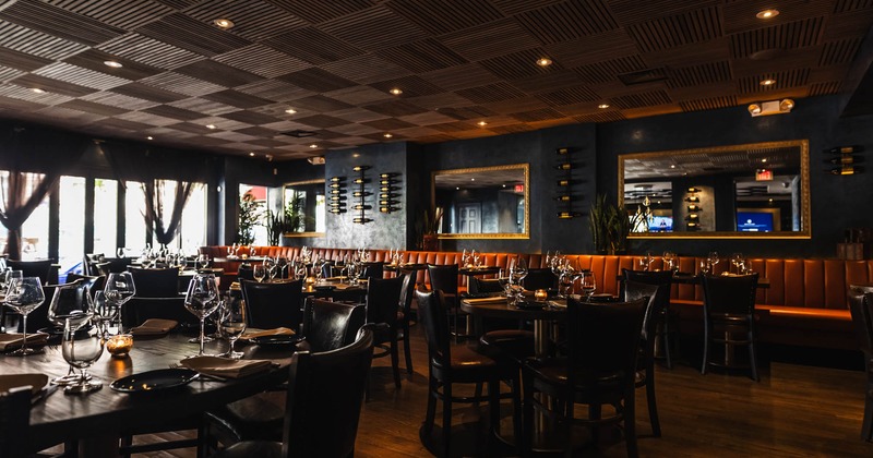 Interior, wide view of dining area, tables and chairs ready for guests