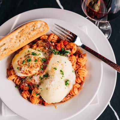 Lazy Lasagna with ricotta, provolone, Parmesan, basil, and red meat sauce.