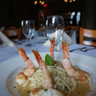 Shrimp linguine in creamy sauce with basil garnish.