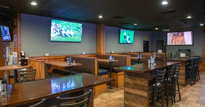 Tables with bar stools and restaurant booths