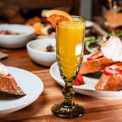 Served food and the Mimosa drink in a glass.