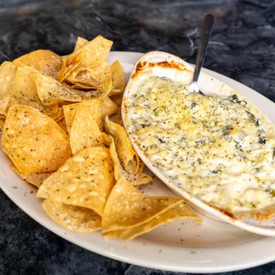 Spinach & Artichoke Dip served with tortilla chips.