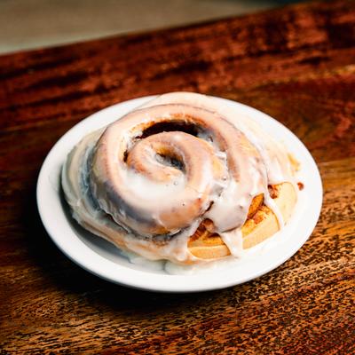 Cinnamon Roll served on a plate.