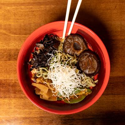 Vegan Curry, with kale and rice noodles, bamboo shoots, snow peas, and mushrooms.