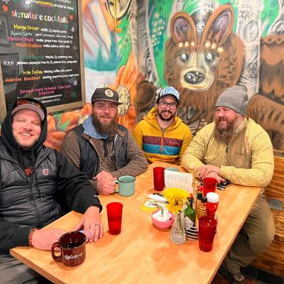 Guests at a table with served drinks.