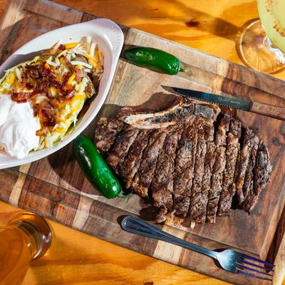 Rib eye steak served with baked potato.