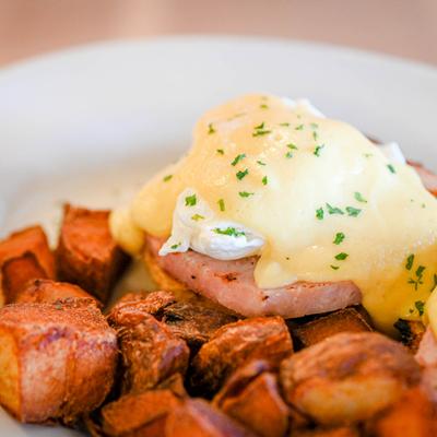 Eggs Benedict with  home fries.