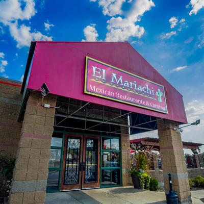 Restaurant's entrance with sign above it.